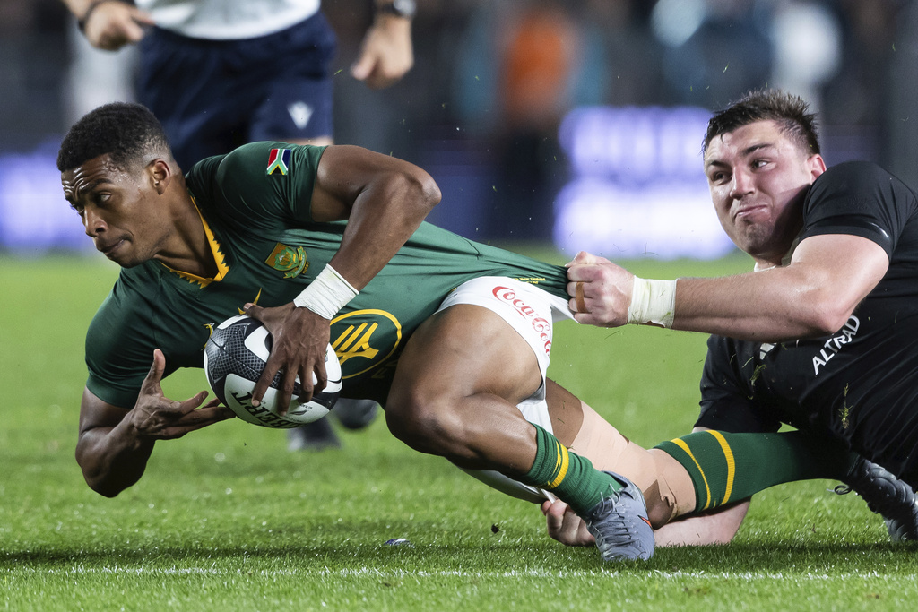 South Africa halfback Grant Williams is tackled by the All Blacks Simon Parker, right, during the rugby international between South Africa and New Zealand at Eden Park in Auckland, New Zealand, Saturday, Sept. 6, 2025. (Brett Phibbs/Photosport via AP)