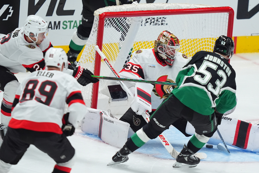 Dallas Stars center Wyatt Johnston (53) scores a goal against Ottawa Senators goaltender Linus Ullmark (35), center Lars Eller (89) and defenseman Artem Zub (2) during the third period of an NHL hockey game Sunday, Nov. 30, 2025, in Dallas. (AP Photo/LM Otero)