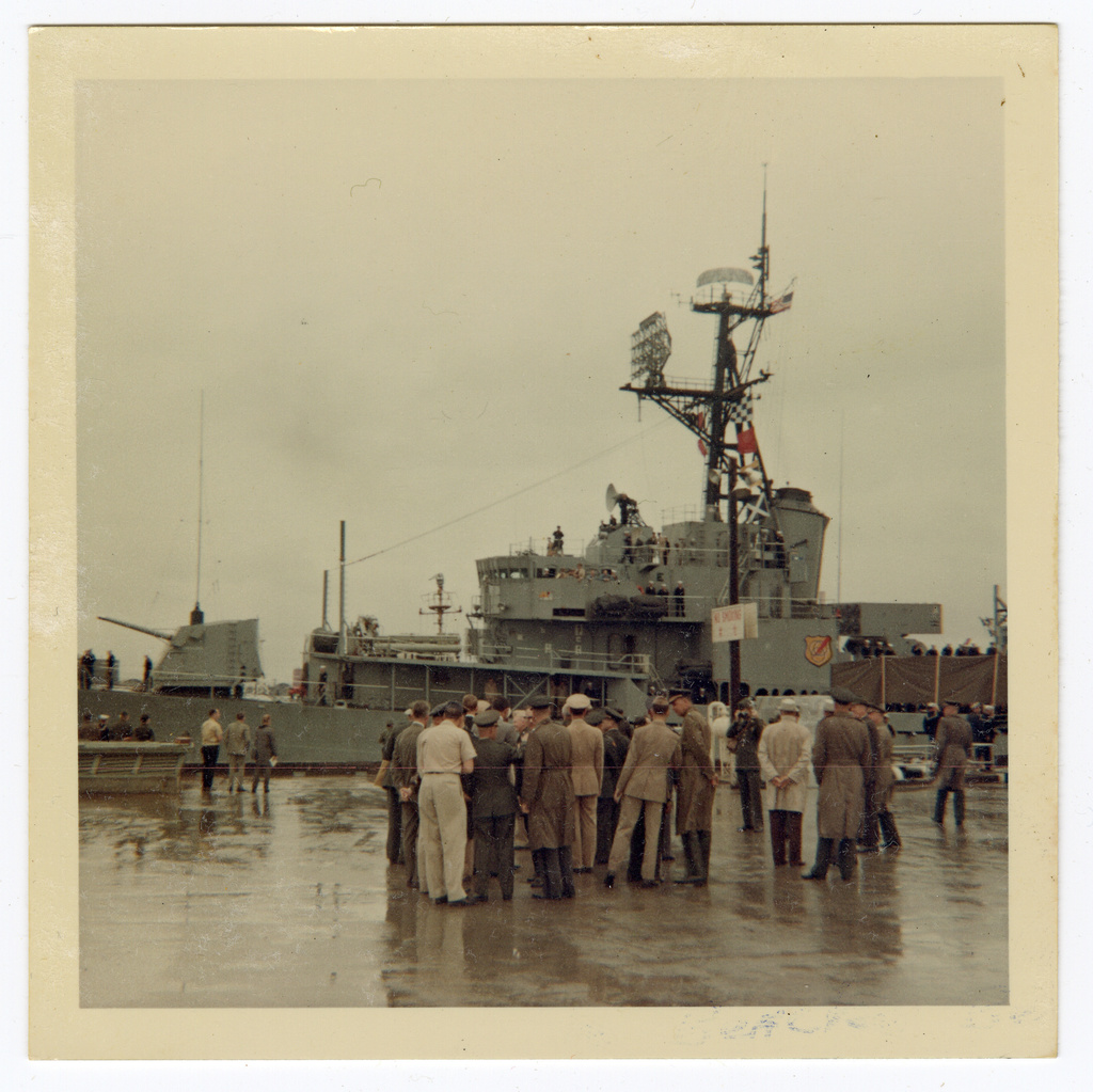 This 1966 image provided by Ron McQueeney shows a crowd of military personnel gathering as astronauts Neil Armstrong and David Scott look out from a ship at Naha Air Base in Okinawa, Japan. (Ron McQueeney/Ohio History Connection via AP)