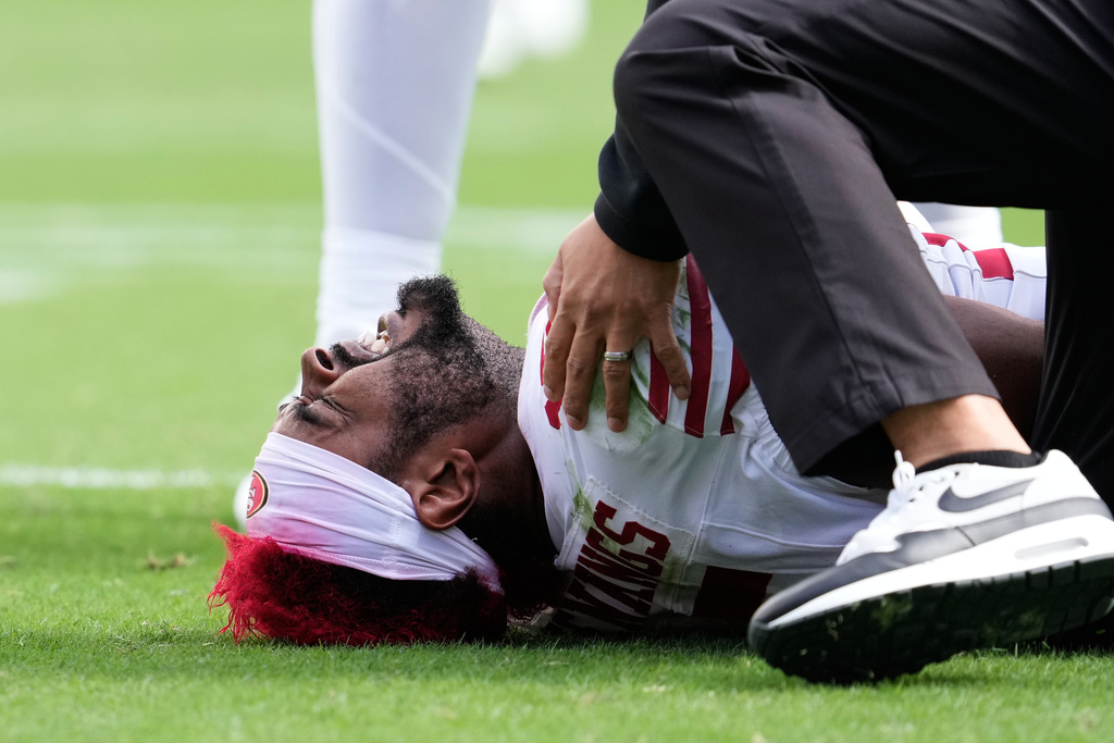 San Francisco 49ers wide receiver Jauan Jennings is tended to after scoring on a two point conversion during the second half of an NFL football game against the Jacksonville Jaguars in Santa Clara, Calif., Sunday, Sept. 28, 2025. (AP Photo/Godofredo A. Vásquez)