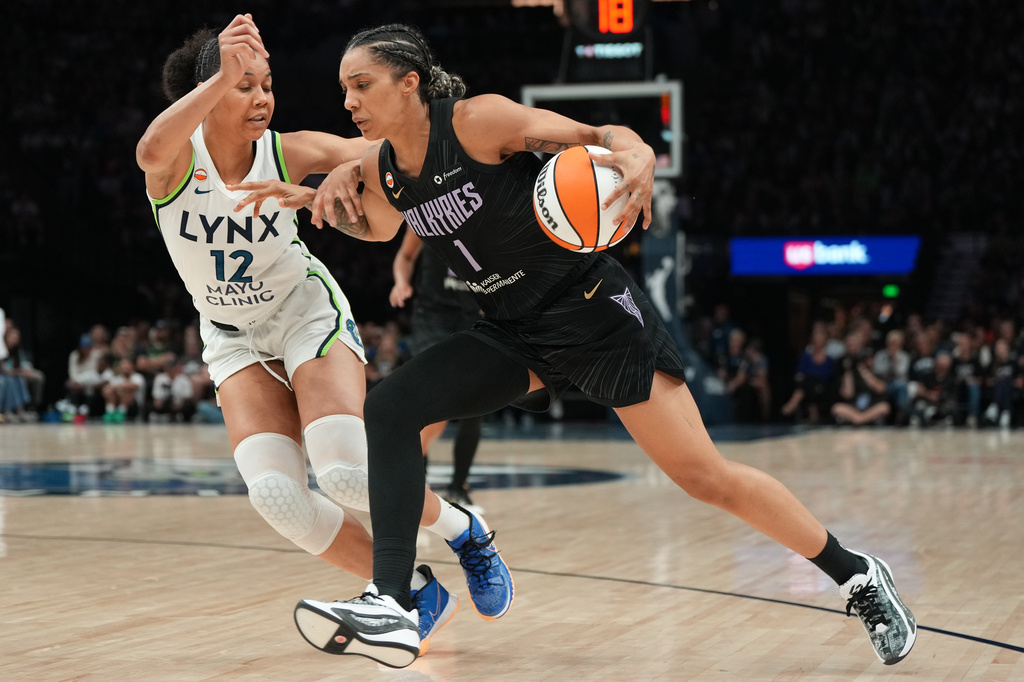 Golden State Valkyries forward Gabby Williams (1) works toward the basket as Minnesota Lynx forward Nia Coffey (12) defends during the second half of a WNBA basketball game Monday, Aug. 24, 2026, in Minneapolis. (AP Photo/Abbie Parr)
