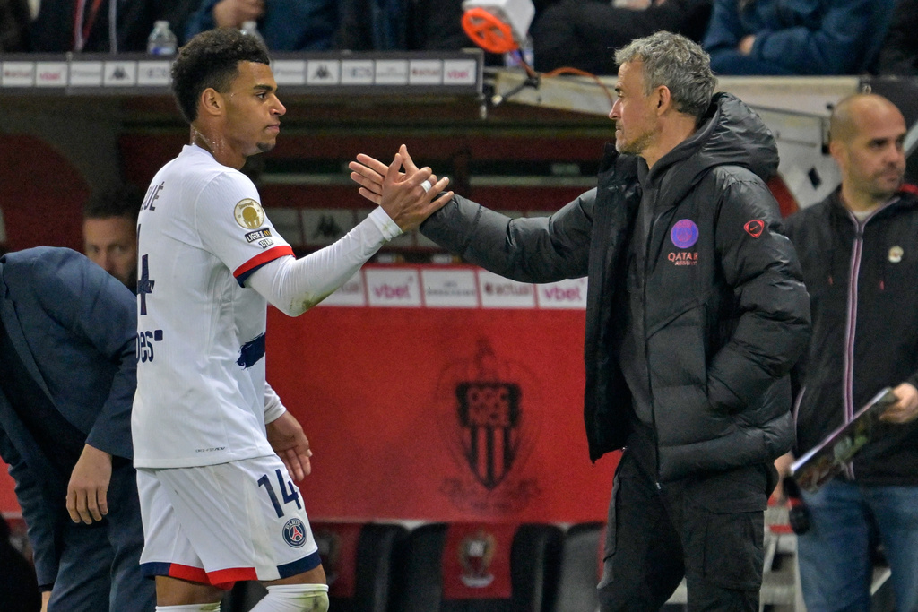 PSG's head coach Luis Enrique greets PSG's Desire Doue during the French League One soccer match between Nice and Paris Saint-Germain in Nice, France, Saturday, March 21, 2026. (AP Photo/Philippe Magoni)