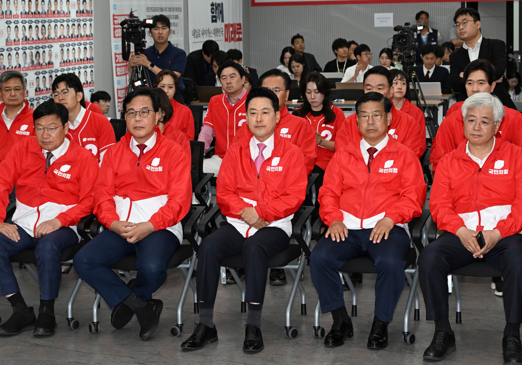 The main opposition People Power Party leader Jang Dong-hyeok, center, and lawmakers watch TVs broadcasting the results of exit polls for the local elections at the party's headquarters in Seoul, South Korea Wednesday, June 3, 2026. (Song Kyung-Seok/Pool Photo via AP)