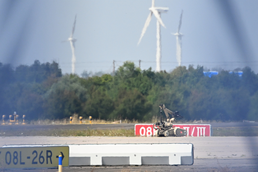 A bomb-disposal robot is being deployed near a Ukrainian aircraft at Leipzig/Halle Airport, in Schkeuditz, Germany, Wednesday Aug. 5, 2026, where flight operations were suspended overnight after a drone sighting was reported and another object was found near a runway. (Hendrik Schmidt/dpa via AP)