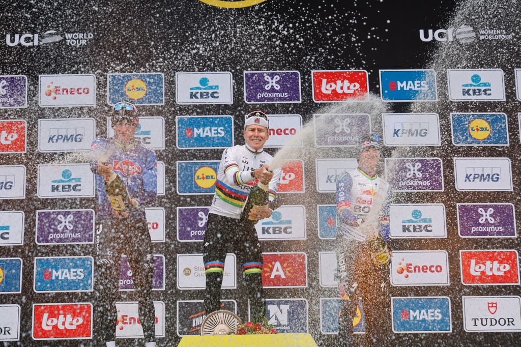 Slovenia's Tadej Pogacar celebrates after winning the Tour of Flanders cycling race, with Netherland's Mathieu Van Der Poel, left, finishing second and Belgium's Remco Evenpoel third in Oudenaarde, Belgium Sunday, April 5, 2026. (AP Photo/Geert Vanden Wijngaert))