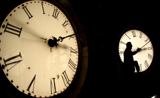 FILE - Custodian Ray Keen inspects a clock face before changing the time on the 100-year-old clock atop the Clay County Courthouse March 8, 2014, in Clay Center, Kan. (AP Photo/Charlie Riedel, File) FILE - Custodian Ray Keen inspects a clock face before changing the time on the 100-year-old clock atop the Clay County Courthouse March 8, 2014, in Clay Center, Kan. (AP Photo/Charlie Riedel, File)