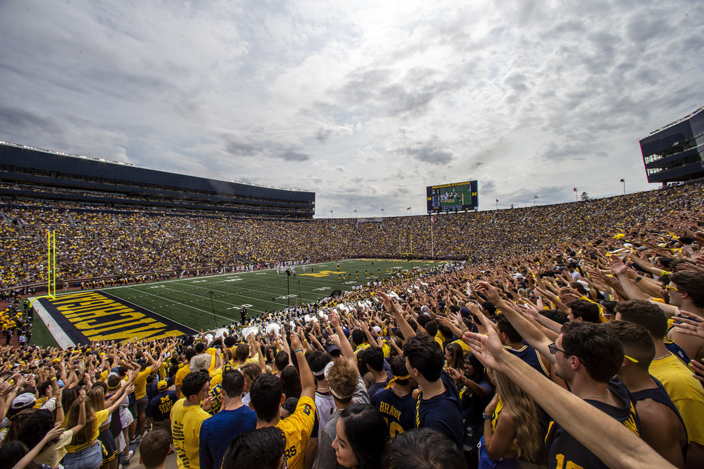 FILE - Michigan fans in the student section of Michigan Stadium cheer during the second quarter of an NCAA college football game against Western Michigan in Ann Arbor, Mich., Saturday, Sept. 4, 2021. (AP Photo/Tony Ding, FIle(