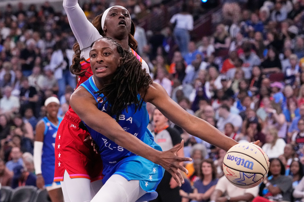 Team Spoon's Nneka Ogwumike, front, looks to pass the ball against Team Coop's Kahleah Copper, top, during the first half of a WNBA All-Star basketball game in Chicago, Saturday, July 25, 2026. (AP Photo/Nam Y. Huh)