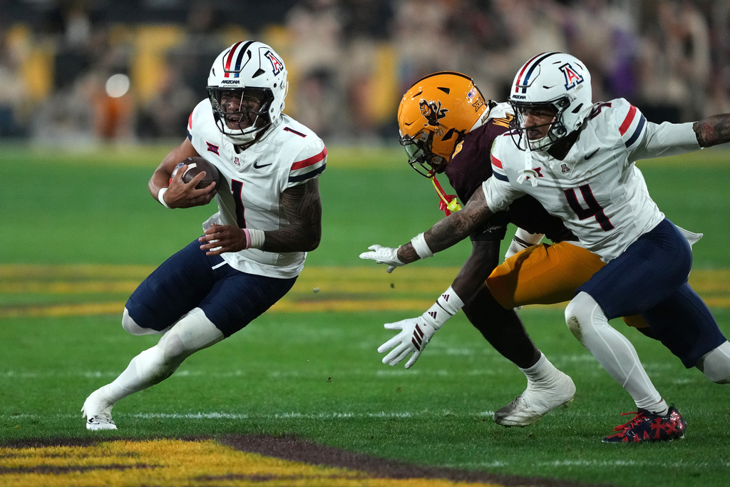 Arizona quarterback Noah Fifita (1) runs the ball against Arizona State in the first half of an NCAA college football game, Friday, Nov. 28, 2025, in Tempe, Ariz. (AP Photo/Rick Scuteri)