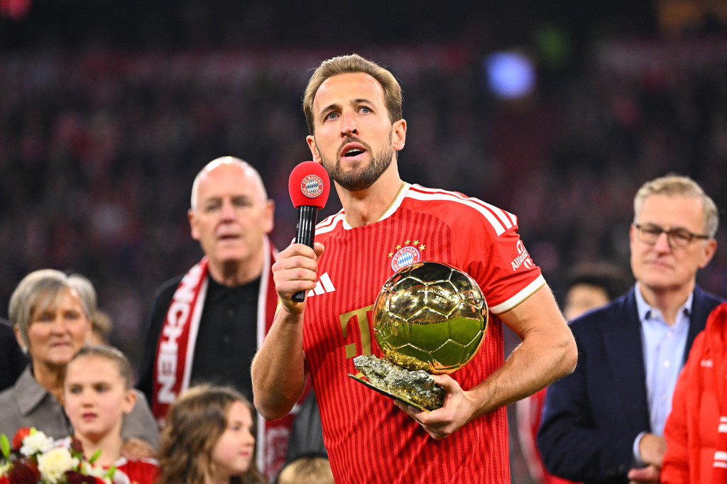 Munich's Harry Kane holds the 2026 Ballon d'Or trophy before the German Bundesliga soccer match between FC Bayern Munich and Borussia Dortmund in Munich, Germany, Saturday, Oct. 31, 2026. (Tom Weller/dpa via AP)