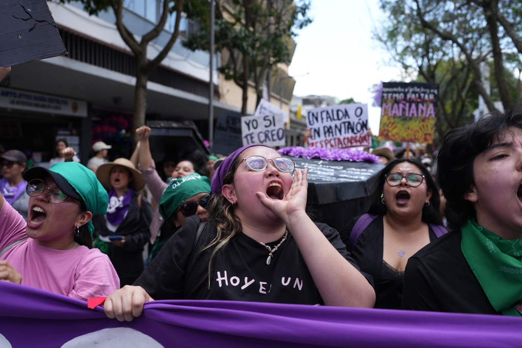 People rally for International Women's Day in Guatemala City, Sunday, March 8, 2026. (AP Photo/Moises Castillo)