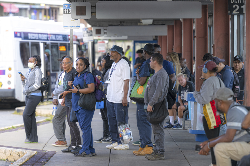 Commuters wait to board a SEPTA bus during the early morning hours at the 69th Street Bus Station in Upper Darby, Pa., Monday, Aug. 25, 2025. (Jose F. Moreno/The Philadelphia Inquirer via AP)