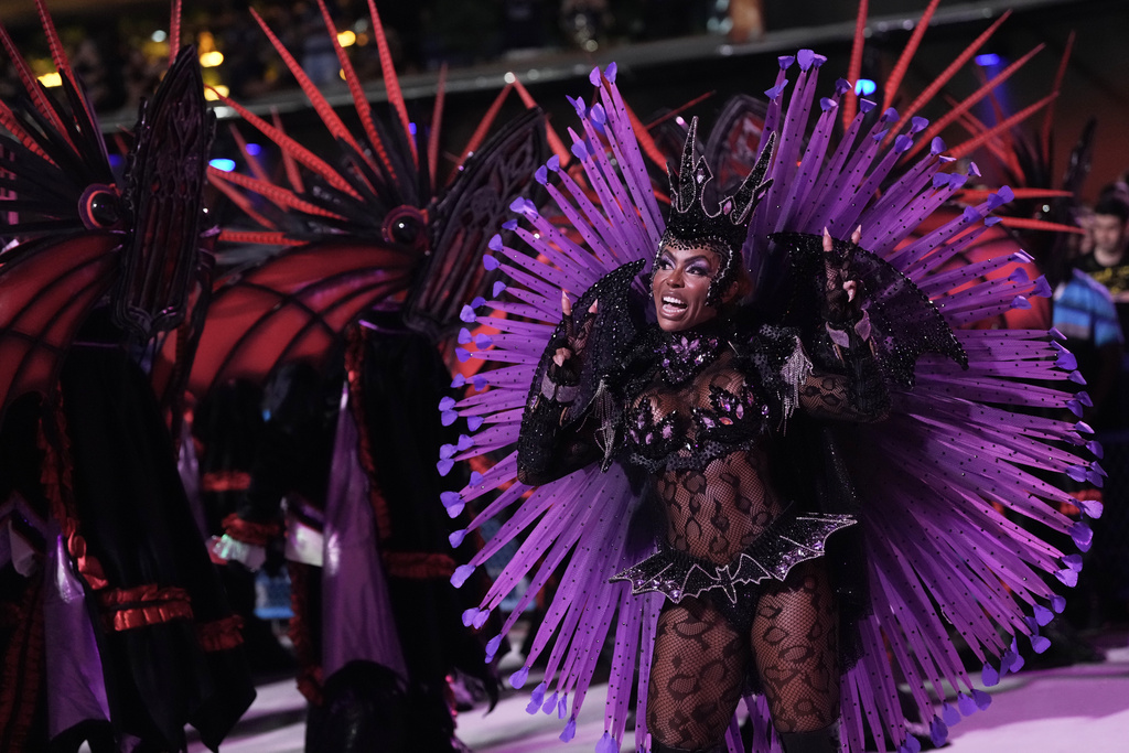 A performer from the Mocidade samba school parades during Carnival celebrations at the Sambadrome in Rio de Janeiro, Monday, Feb. 16, 2026. (AP Photo/Silvia Izquierdo)