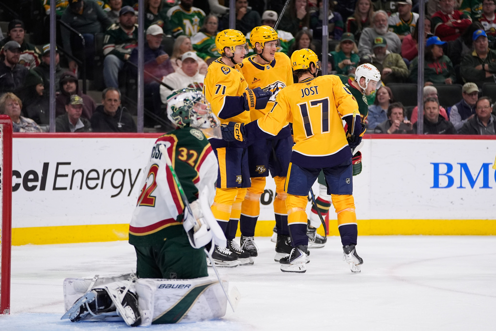 Nashville Predators right wing Matthew Wood (71), middle, left, celebrates with teammates after scoring a goal during the second period of an NHL hockey game against the Minnesota Wild, Tuesday, Nov. 4, 2025, in St. Paul, Minn. (AP Photo/Abbie Parr)