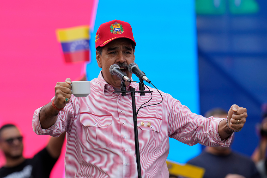 Venezuelan President Nicolas Maduro addresses supporters during a swearing-in event for government-organized neighborhood committees at the presidential palace in Caracas, Venezuela, Monday, Dec. 1, 2025. (AP Photo/Ariana Cubillos)