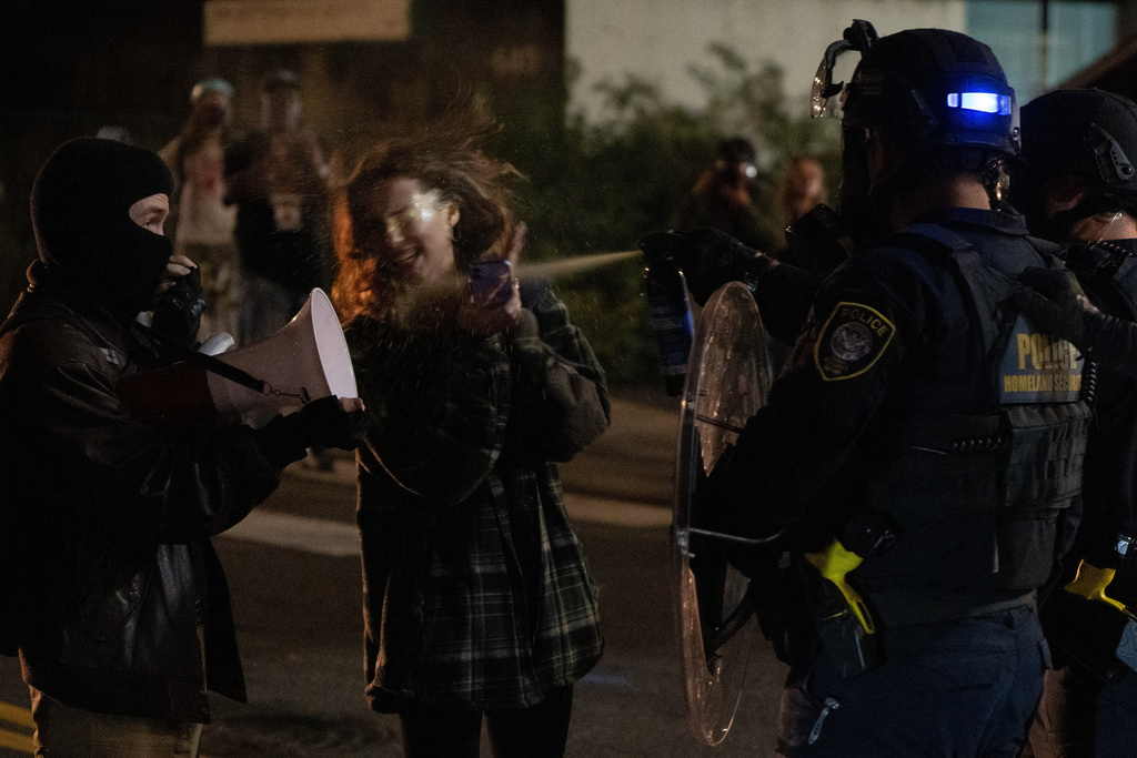 A protester is sprayed by a Department of Homeland Security officer outside a U.S. Immigration and Customs Enforcement facility, Oct. 2, 2025, in Portland, Ore. (AP Photo/Jenny Kane, File)