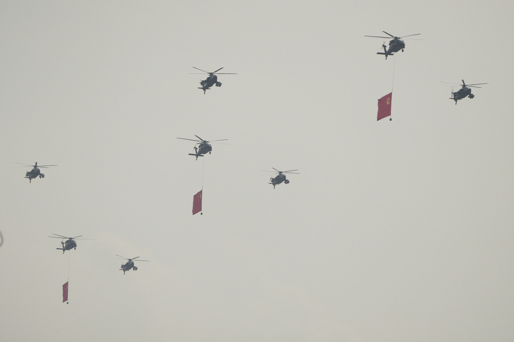 Helicopters take part in a military parade to commemorate the 80th anniversary of Japan's World War II surrender held in front of Tiananmen Gate in Beijing, Wednesday, Sept. 3, 2025. (AP Photo/Andy Wong)