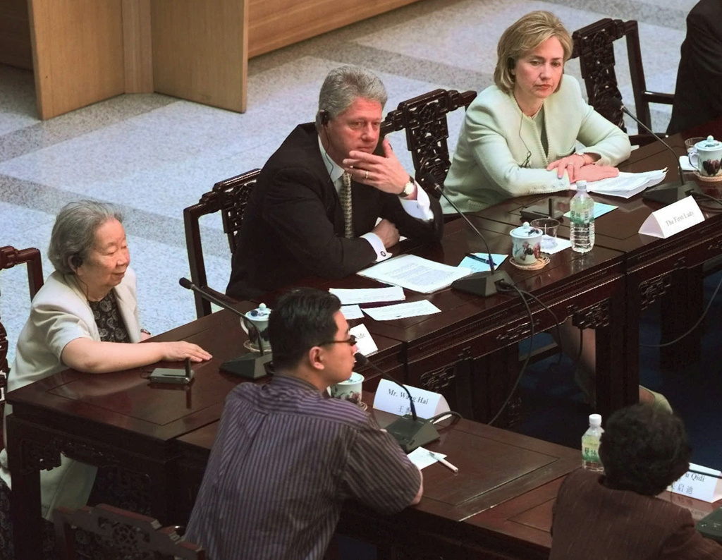 FILE - President Clinton, center, and first lady Hillary Rodham Clinton, right, participate in a round table discussion with local Chinese community leaders in Shanghai on "Shaping China for the 21st Century" at the Shanghai Library, June 30, 1998. (AP Photo/J. Scott Applewhite, File)