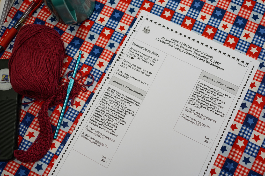 A stack of State of Maine ballots sits next to an election official's knitting yarn, Tuesday, Nov. 4, 2025, in Sullivan, Maine. (AP Photo/Robert F. Bukaty)