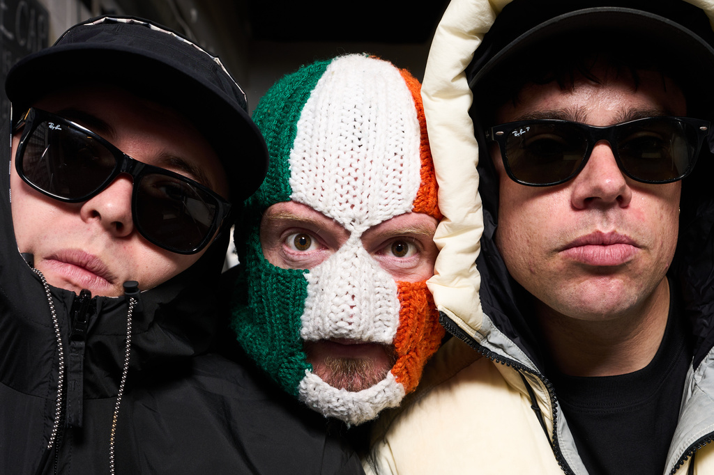 Liam Og O hAnnaidh, aka Mo Chara, from left, J. J. O Dochartaigh, aka DJ Provai and Naoise O Caireallain, aka Moglai Bap, from the band Kneecap pose for portrait photographs on Thursday, April 30, 2026, in London. (Photo by Scott A Garfitt/Invision/AP)