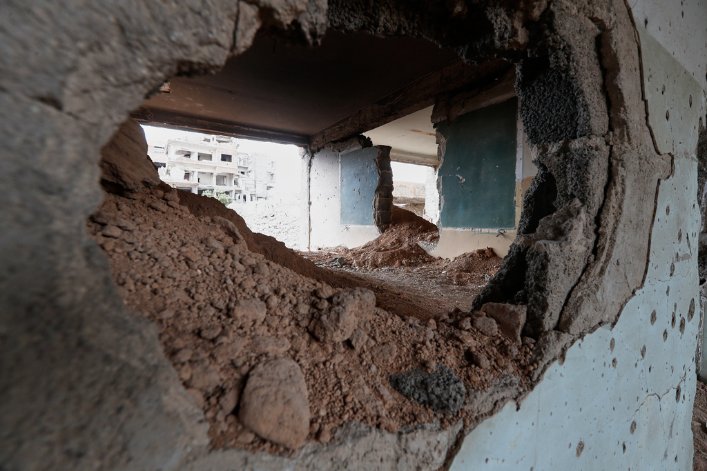 A classroom inside a school destroyed during the fighting between forces loyal to former President Bashar Assad and rebel groups is seen in the devastated Jobar neighborhood of Damascus, Syria, Thursday, Sept. 25, 2025. (AP Photo/Omar Sanadiki)