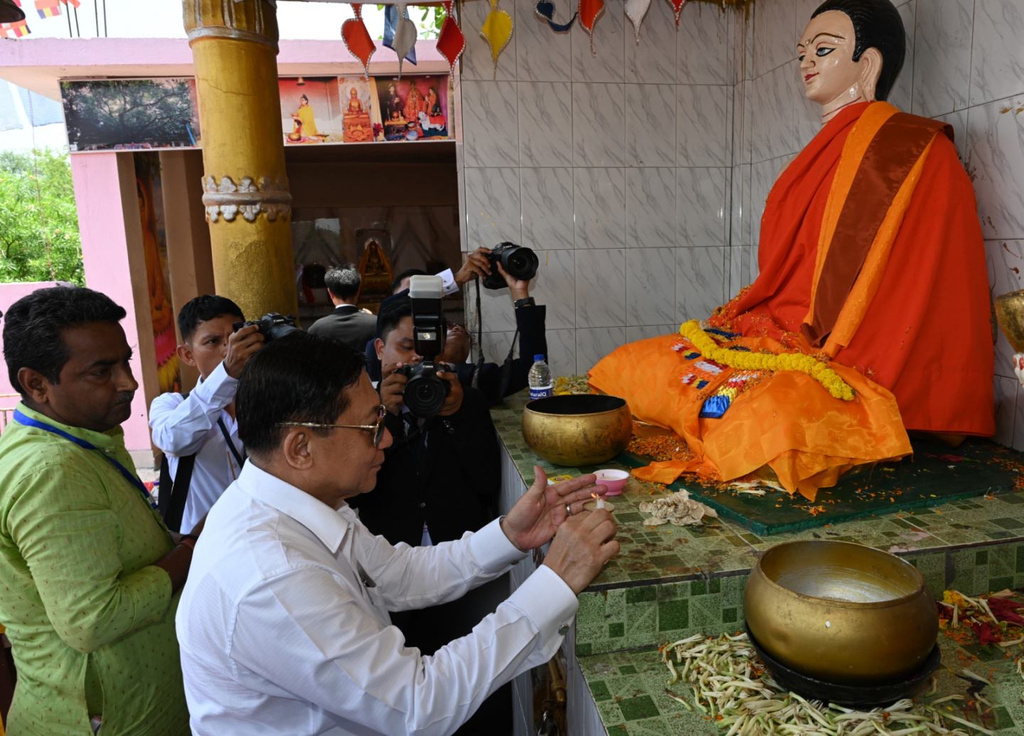 In this photo provided by Myanmar Military True News Information Team on Saturday, May 30, 2026, Myanmar President Min Aung Hlaing offers candles in front of a Buddha statue as he visits Bodh Gaya, in India on May 30. (Myanmar Military True News Information Team via AP)