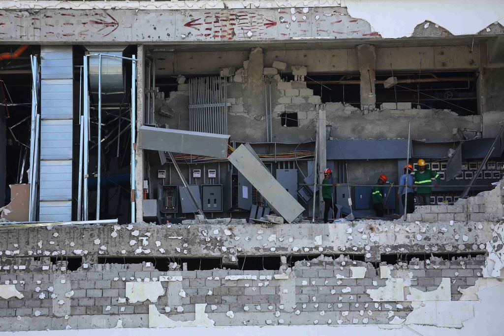 Workers inspect a damaged mall in General Santos, southern Philippines, Thursday, June 11, 2026, following Monday's powerful earthquake. (AP Photo/Basilio Sepe)