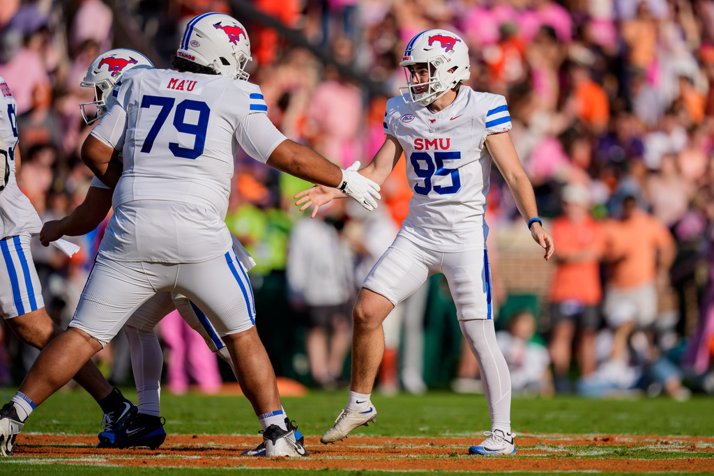 SMU kicker Sam Keltner (95) celebrates his field goal against Clemson with offensive lineman Sione Ma'U (79) in the first half of an NCAA college football game Saturday, Oct. 18, 2025, in Clemson, S.C. (AP Photo/Jacob Kupferman)