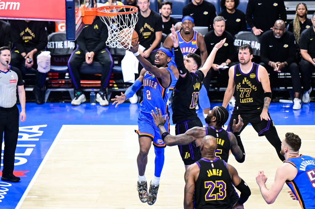 Oklahoma City Thunder guard Shai Gilgeous-Alexander (2) shoots against Los Angeles Lakers forward Jake LaRavia (12) during the second half of an NBA basketball game Thursday, April 2, 2026, in Oklahoma City. (AP Photo/Gerald Leong)