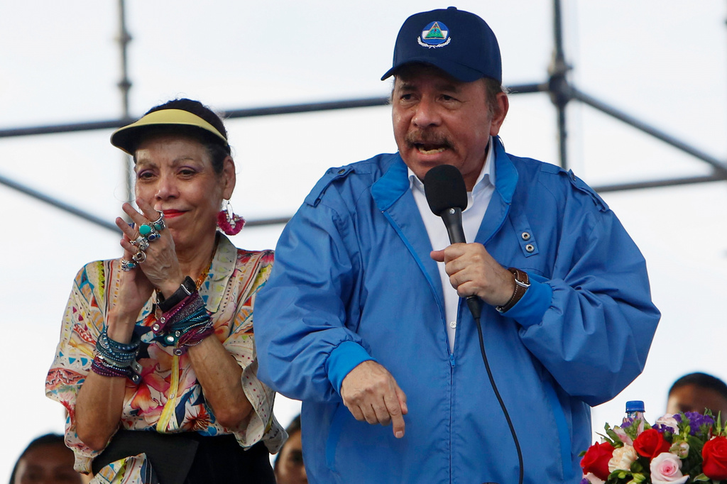 FILE - Nicaragua's President Daniel Ortega speaks to supporters as his wife and Vice President Rosario Murillo applauds, in Managua, Nicaragua, Aug. 29, 2018. (AP Photo/Alfredo Zuniga, File)