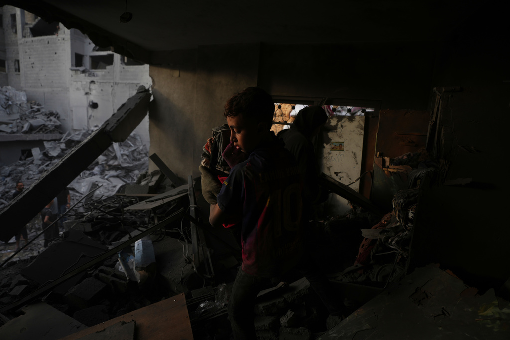Palestinians save their belongings from buildings destroyed by an Israeli airstrike late Thursday in Gaza city, Friday, Oct. 9, 2026. (AP Photo/Jehad Alshrafi)