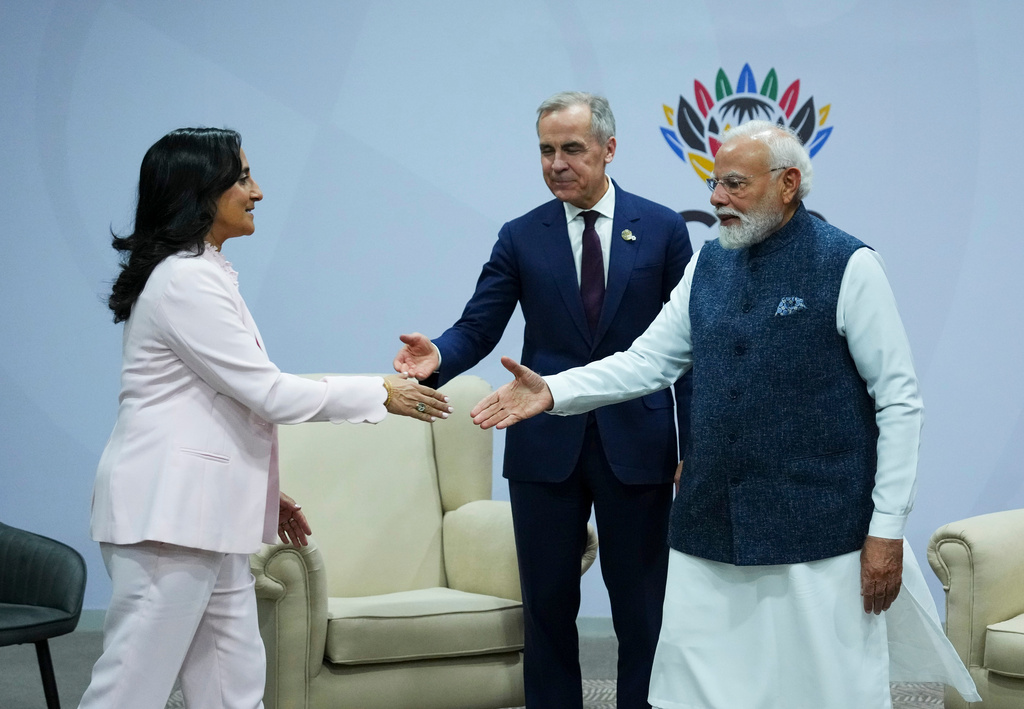 Canada's Prime Minister Mark Carney, middle, introduces Minister of Foreign Affairs Anita Anand, left, during a bilateral meeting with Indian Prime Minister Narendra Modi during the G20 Summit, in Johannesburg, Sunday, Nov. 23, 2025. (Sean Kilpatrick/The Canadian Press via AP)