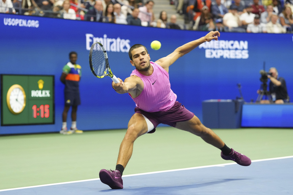 Carlos Alcaraz, of Spain, returns a shot to Jannik Sinner, of Italy, during the men's singles final of the U.S. Open tennis championships, Sunday, Sept. 7, 2025, in New York. (AP Photo/Kirsty Wigglesworth)