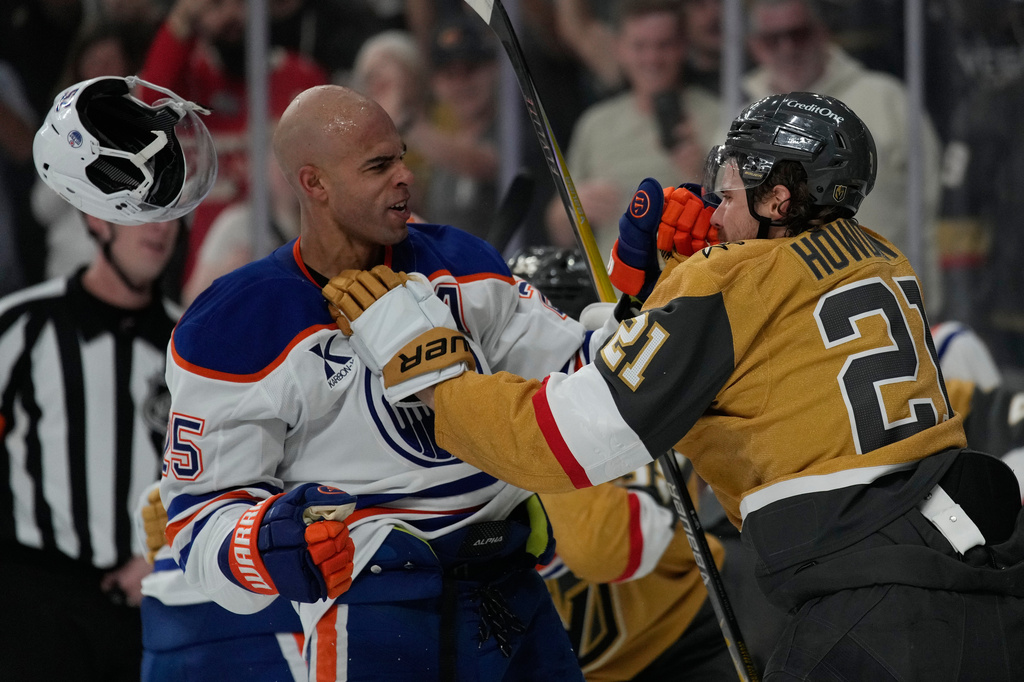 Vegas Golden Knights center Brett Howden (21) and Edmonton Oilers defenseman Darnell Nurse (25) fight during the first period of an NHL hockey game Thursday, March 26, 2026, in Las Vegas. (AP Photo/John Locher)
