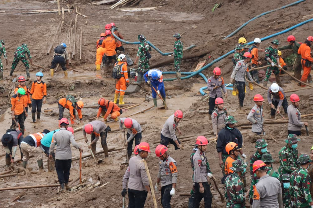 In this photo released by Indonesia's National Disaster Management Agency (BNPB) rescuers search for victims in Pasir Langu village after a landslide, in West Bandung district of West Java province, Indonesia, Monday, Jan. 26, 2026. (BNPB via AP)