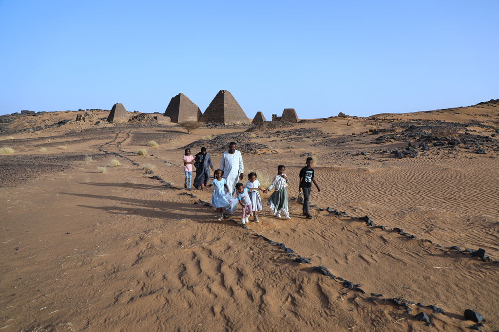 A family visits the Meroe pyramids at the Meroe archaeological site in Bejrawiya, Sudan, Friday, July 31, 2026. (AP Photo/Mohnd Blal)