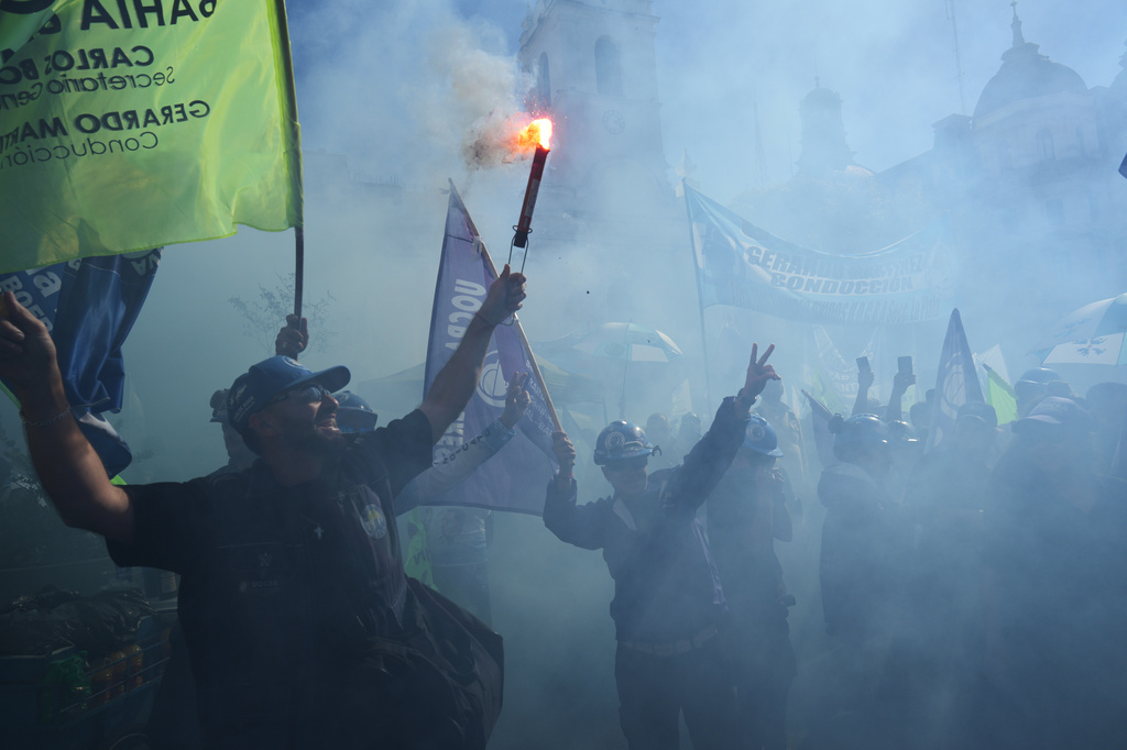 Laborers hold flares during a May Day demonstration in Buenos Aires, Argentina, Thursday, April 30, 2026. (AP Photo/Rodrigo Abd)