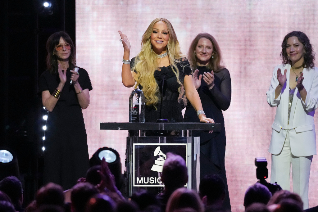 Mariah Carey, center, accepts the 2026 MusiCares Persons of the Year award during MusiCares Person of the Year honoring Mariah Carey on Friday, Jan. 30, 2026, in Los Angeles. (AP Photo/Chris Pizzello)