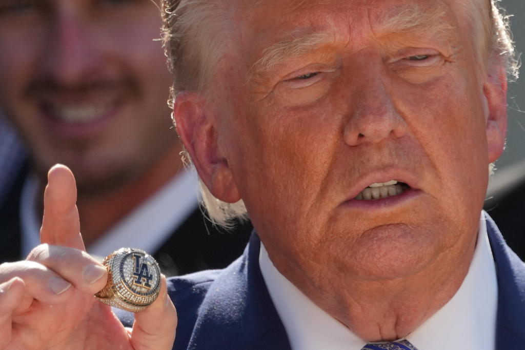 President Donald Trump holds a championship ring during an event to honor the 2025 World Series champions Los Angeles Dodgers in the Rose Garden of the White House, Thursday, July 23, 2026, in Washington. (AP Photo/Alex Brandon)