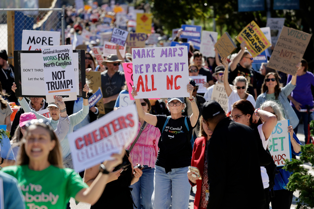 Marchers proceed from the Capitol during a rally protesting a proposed redistricting map Tuesday, Oct. 21, 2025, in Raleigh, N.C. (AP Photo/Chris Seward)