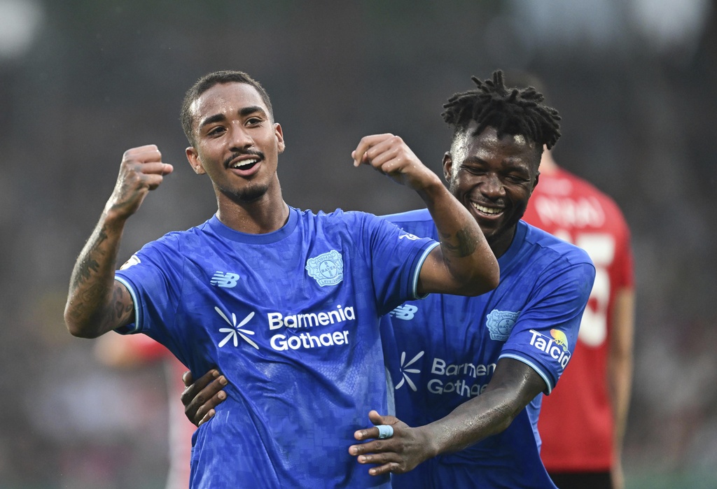 Leverkusen's Arthur celebrates scoring with Edmond Tapsoba, right, during the DFB Cup 1st round soccer match between SG Sonnenhof Großaspach and Bayer Leverkusen at WIRmachenDRUCK Arena, Aspach, Germany, Friday Aug. 15, 2025. (Bernd Weißbrod/dpa via AP)
