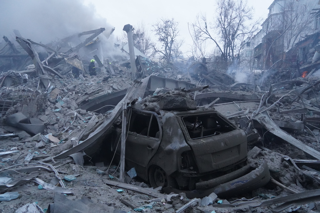 Emergency services personnel work to extinguish a fire following a Russian missile attack in Kharkiv, Ukraine, Friday, Jan. 2, 2026. (AP Photo/Andrii Marienko)