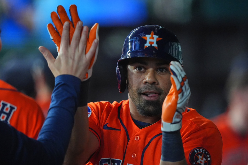Houston Astros' LaMonte Wade Jr. is congratulated in the dugout after hitting a grand slam during the third inning of a baseball game against the Texas Rangers, Saturday, July 11, 2026, in Arlington, Texas. (AP Photo/LM Otero)