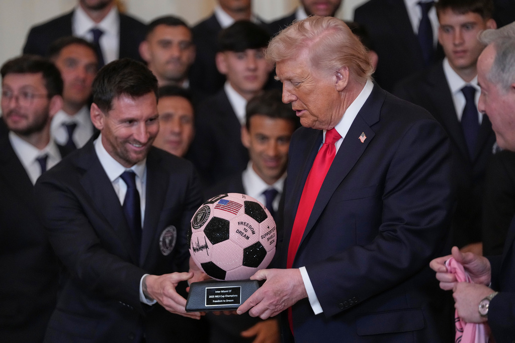 President Donald Trump receives a soccer ball trophy from Lionel Messi during an event to honor the 2025 Major League Soccer champions Inter Miami in the East Room of the White House, Thursday, March 5, 2026, in Washington. (AP Photo/Julia Demaree Nikhinson)
