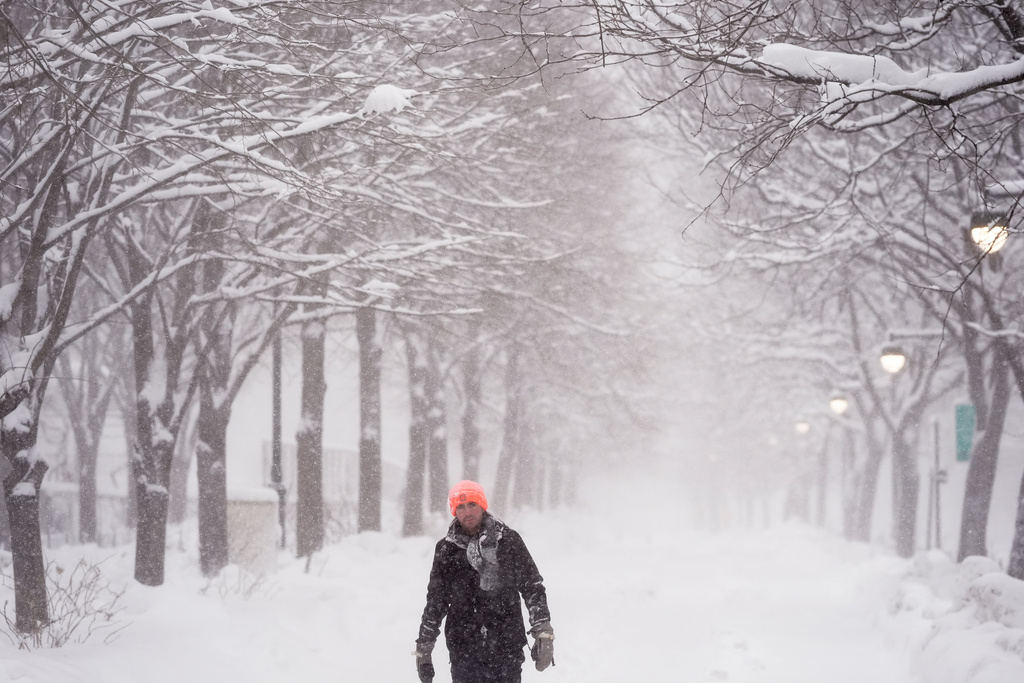 A man walks along the Hudson River Greenway in lower Manhattan during a snow storm, Monday, Feb. 23, 2026, in New York. (AP Photo/Seth Wenig)