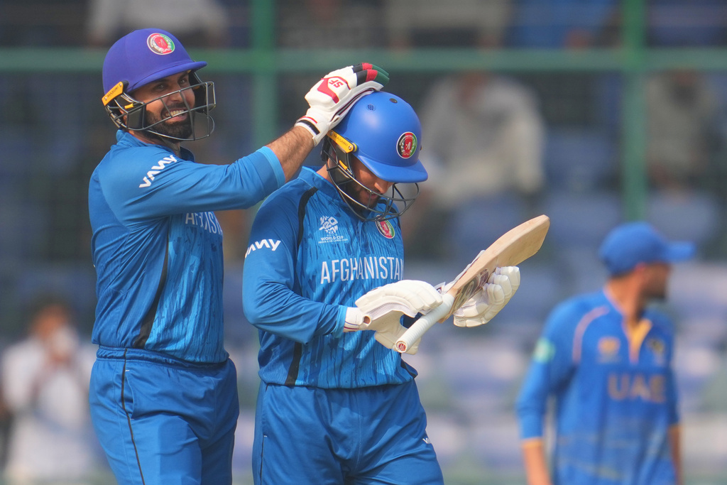 Afghanistan's Mohammad Nabi congratulate teammate Afghanistan's Azmatullah Omarzai after wining against United Arab Emirates during the T20 World Cup cricket match in New Delhi, India, Monday, Feb. 16, 2026. (AP Photo/Manish Swarup)