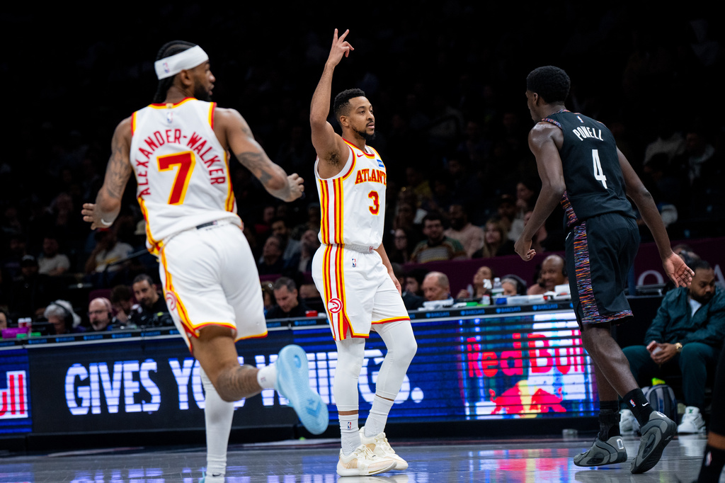 Atlanta Hawks guard CJ McCollum (3) celebrates scoring a three-pointer during the first half of an NBA basketball game against the Brooklyn Nets, Friday, April 3, 2026, in New York. (AP Photo/Angelina Katsanis)