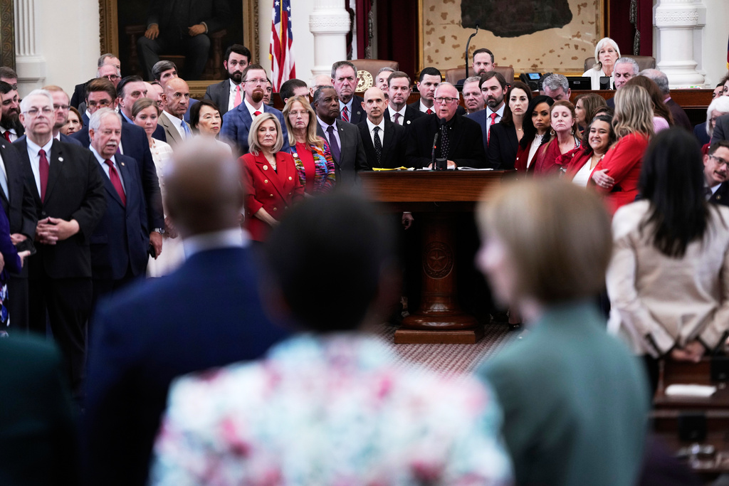 Texas Rep. Todd Hunter, R-Corpus Christi, is surrounded by fellow Republicans as he faces off with Democrats during debate over a redrawn U.S. congressional map in Texas during a special session, Wednesday, Aug. 20, 2025, in Austin, Texas. (AP Photo/Eric Gay)
