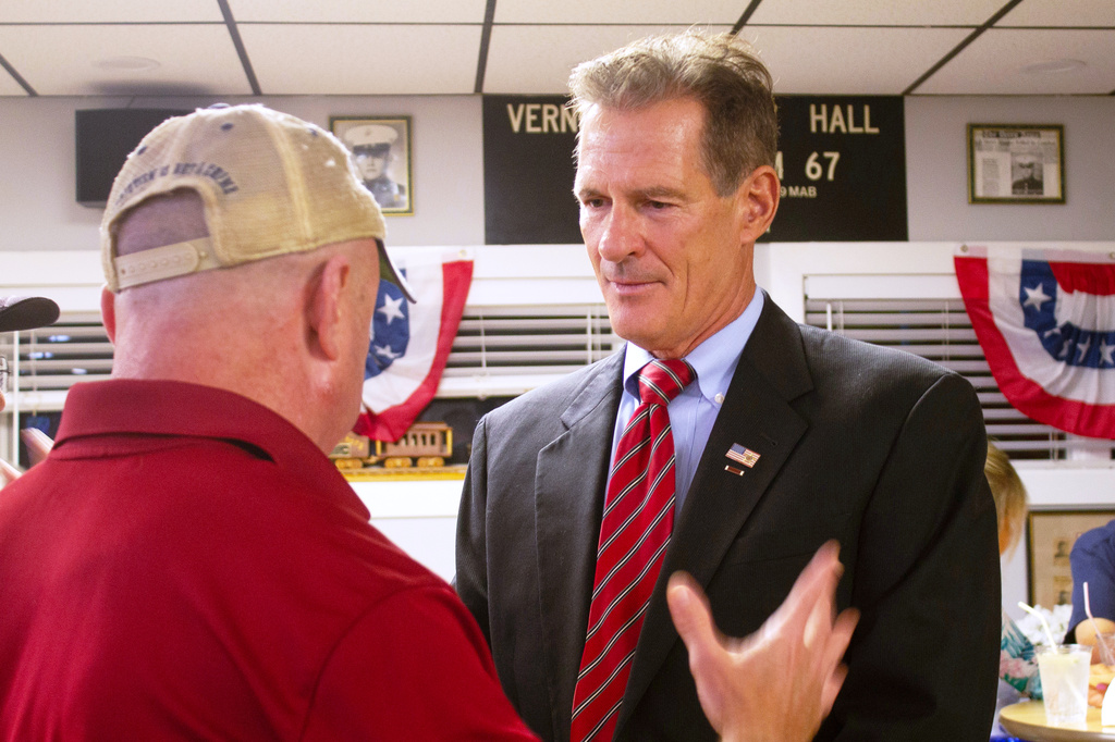 Former U.S. Sen. Scott Brown listens to a voter in Londonderry, New Hampshire, on Thursday, Aug. 27, 2026, as he campaigns for the GOP nomination for the state’s open Senate seat. (AP Photo/Holly Ramer)
