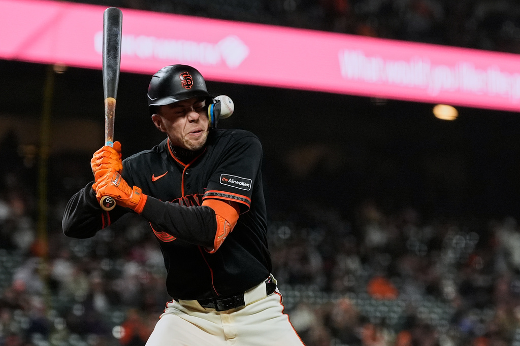 San Francisco Giants' Christian Koss is hit by a pitch during the ninth inning of a baseball game against the Pittsburgh Pirates, Saturday, May 9, 2026, in San Francisco. (AP Photo/Godofredo A. Vásquez)
